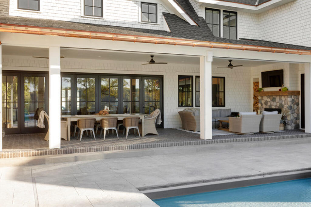 outdoor dining by the pool by konen homes